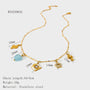 Gold necklace with charms and measurements on a white background