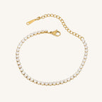Gold bracelet with clear stones on a white background