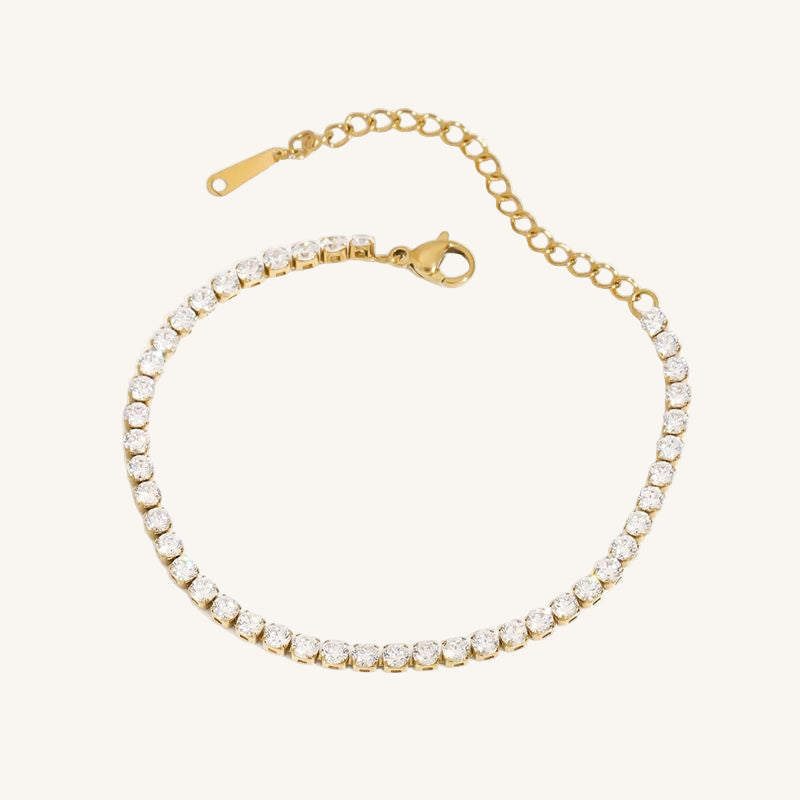 Gold bracelet with clear stones on a white background