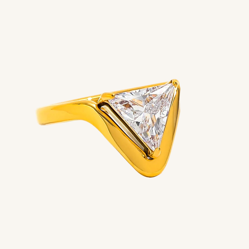 Gold ring with a triangular diamond on a white background
