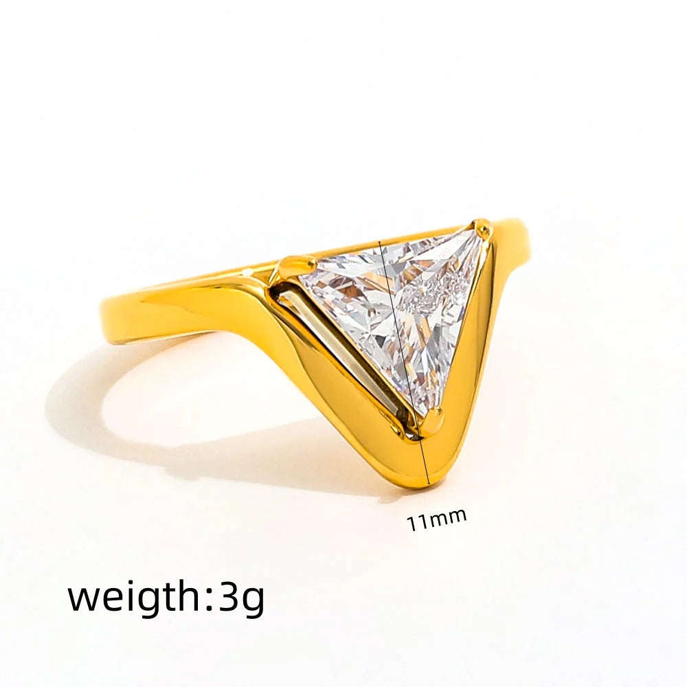 Gold ring with a large diamond on a white background