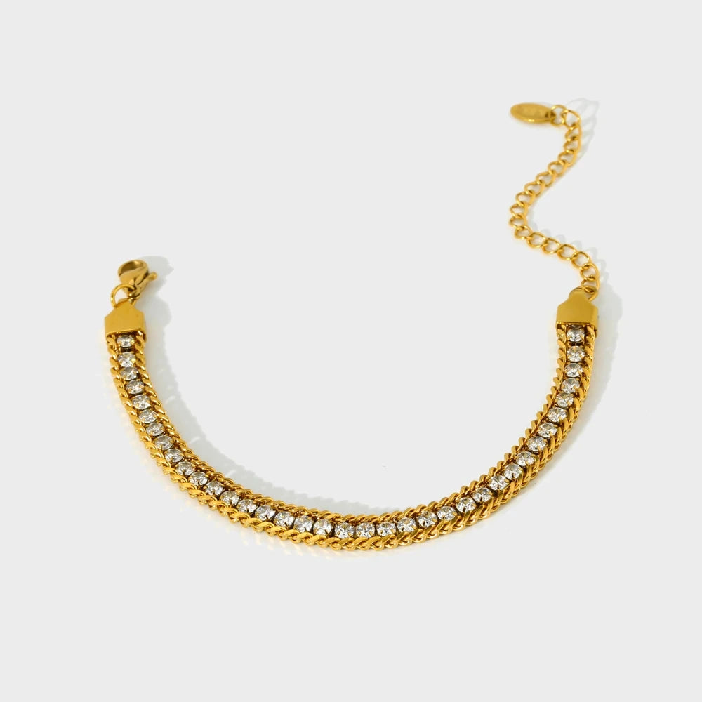 Gold bracelet with rhinestones on a white background