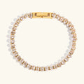 Gold and pearl bracelet on a white background