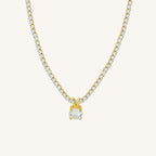 Gold necklace with a diamond pendant on a white background