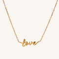 Gold necklace with 'love' pendant on a white background