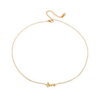 Gold necklace with 'love' pendant on a white background