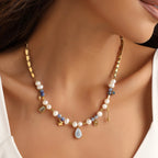 Necklace with pearls and gemstones worn by a person