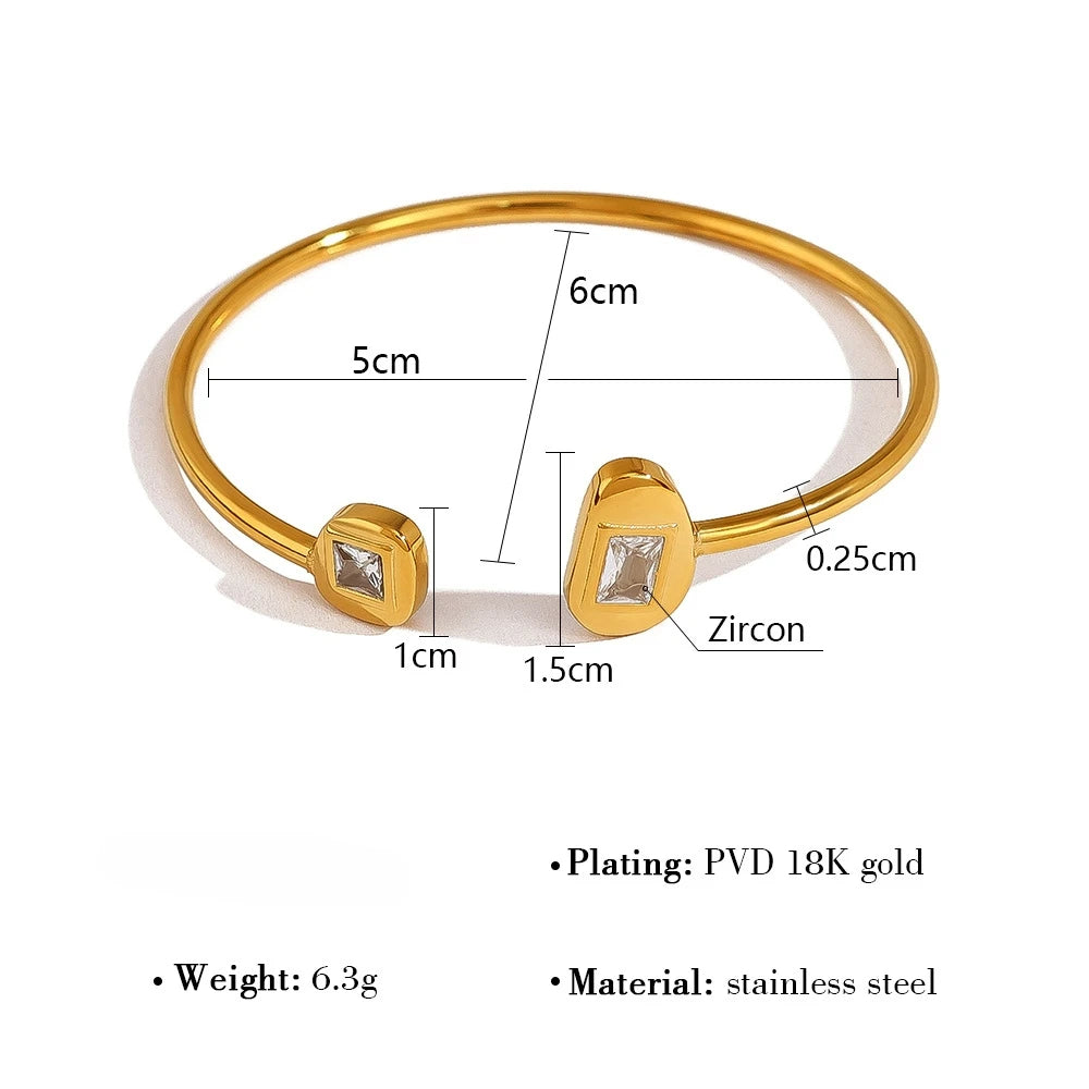 Gold bracelet with zirconia stones and measurement details on a white background