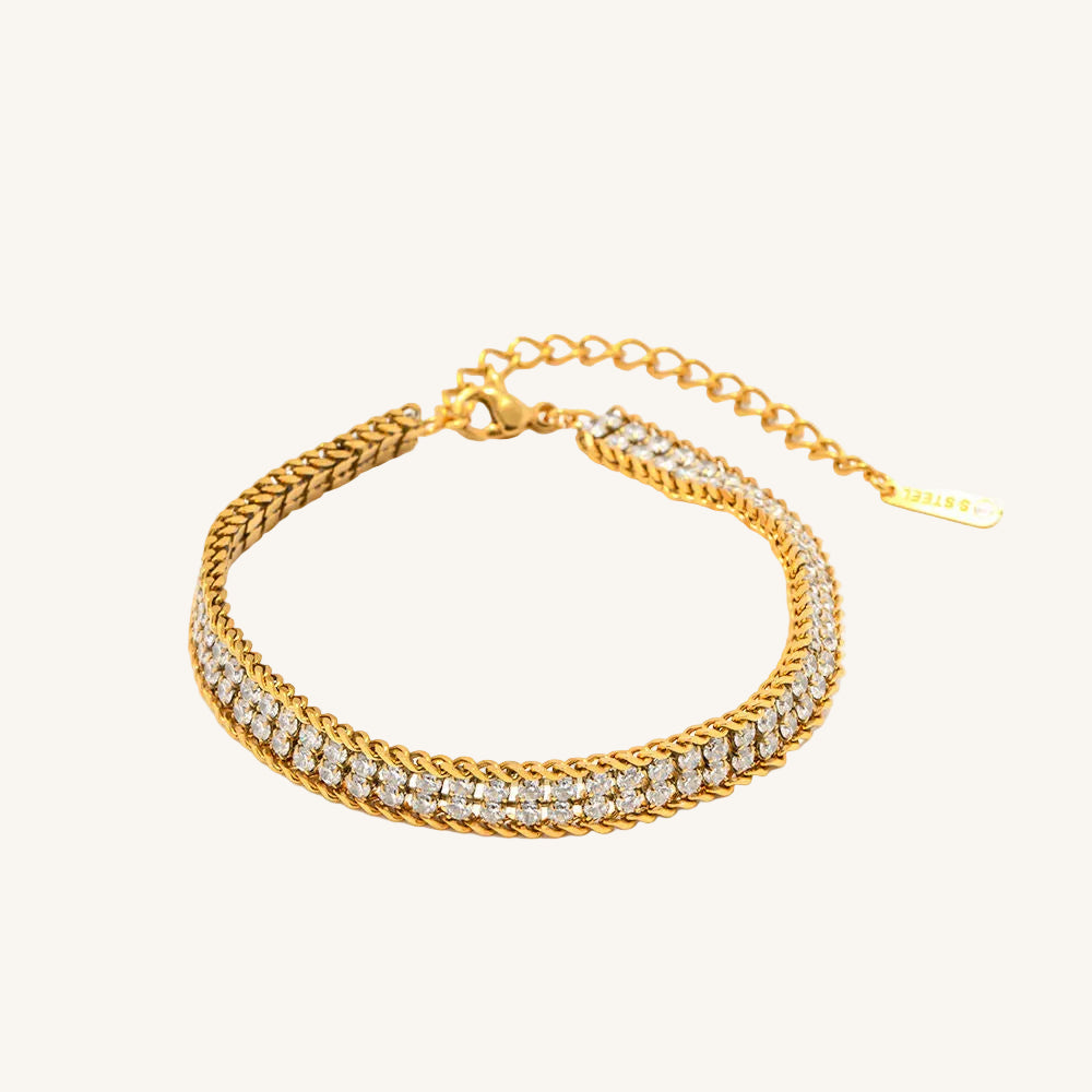 Gold bracelet with diamond accents on a white background
