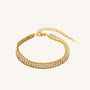 Gold bracelet with diamond accents on a white background