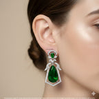 Blue teardrop earring worn by a model on a beige background