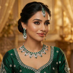 Woman wearing green and silver jewelry set with a blurred golden background
