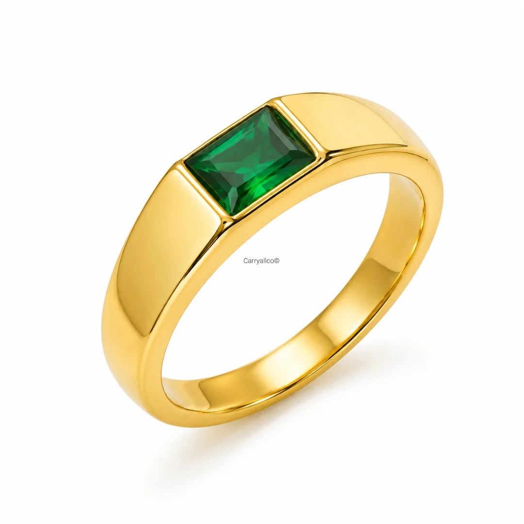 Gold ring with a green gemstone on a white background