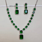 Green gemstone necklace and earrings set on a white background with 'CARRYALLCO' branding.