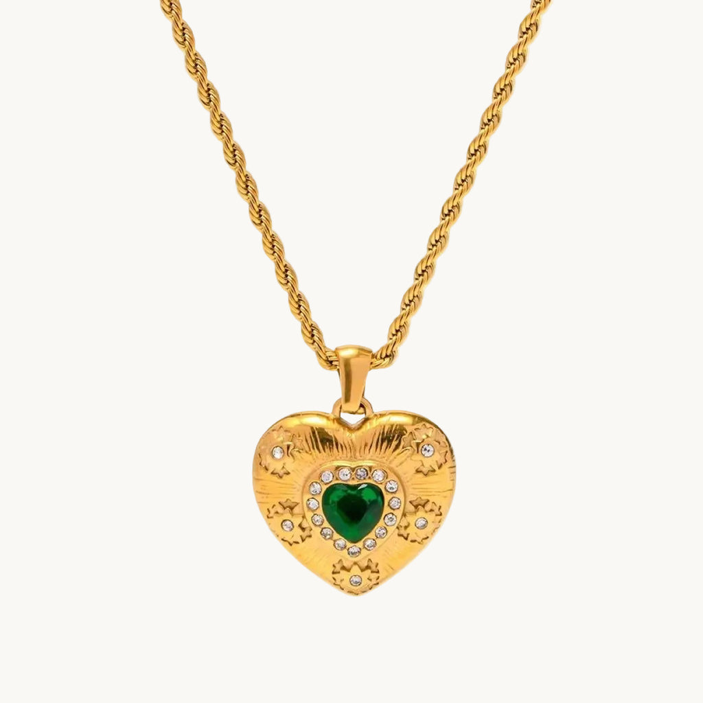 Gold heart-shaped necklace with a green gemstone on a white background