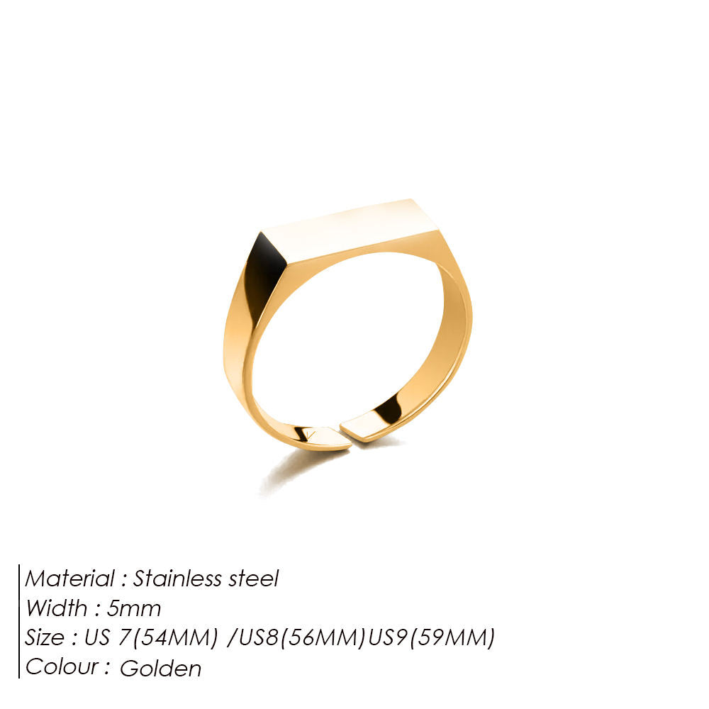 Gold ring with black accent on a white background