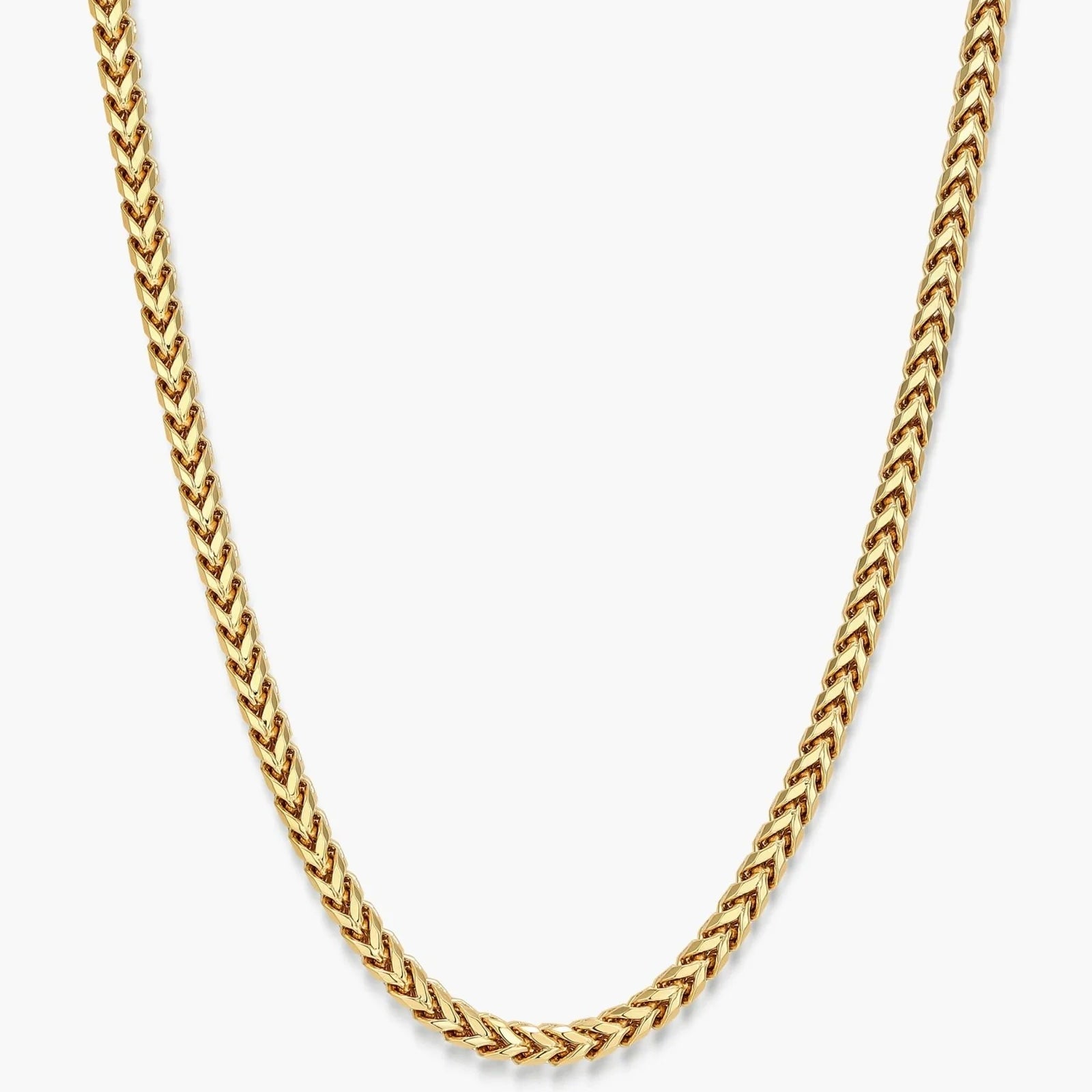 A gold-toned chain necklace with a braided or woven link design, shown against a plain light gray background.