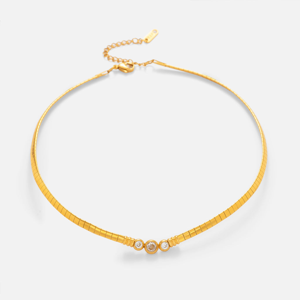 Gold necklace with a small clasp on a white background