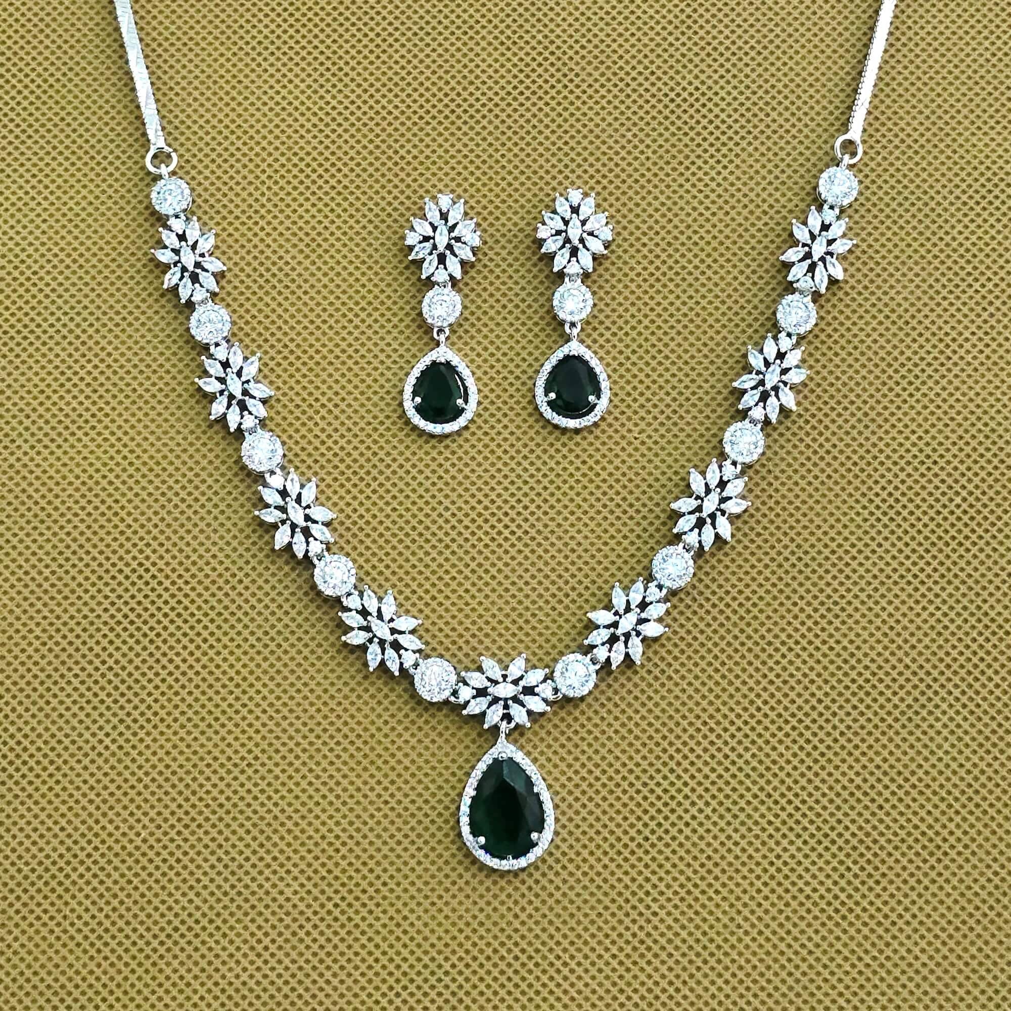 Jewelry set with necklace and earrings on a beige background