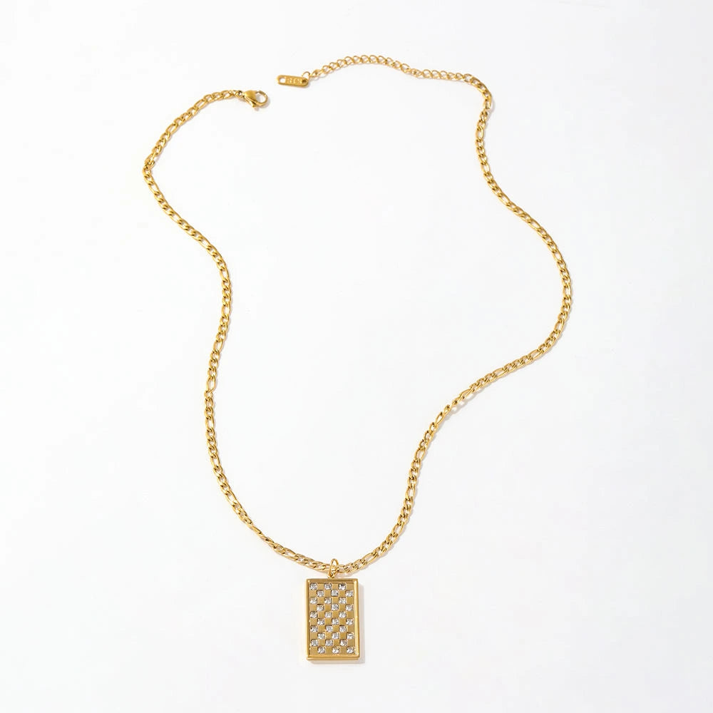 Gold necklace with a rectangular pendant on a white background