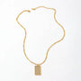 Gold necklace with a rectangular pendant on a white background
