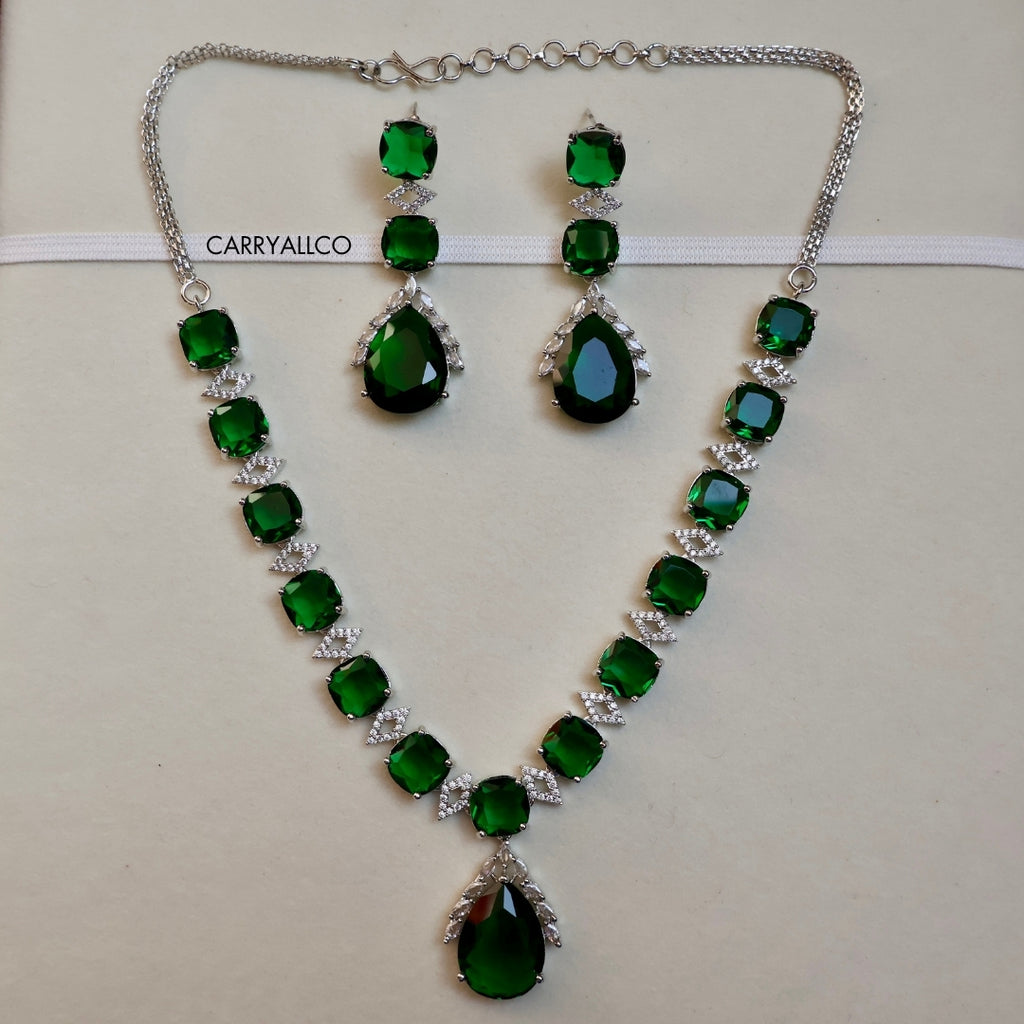 Green gemstone necklace and earrings set with 'CARRYALICO' branding on a light background