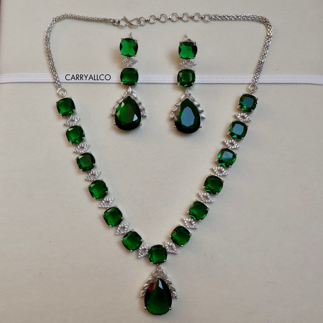 Green gemstone necklace and earrings set with 'CARRYALICO' branding on a light background