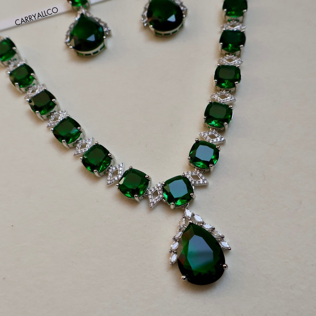 Necklace with green gemstones on a light background