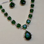Necklace with green gemstones on a light background