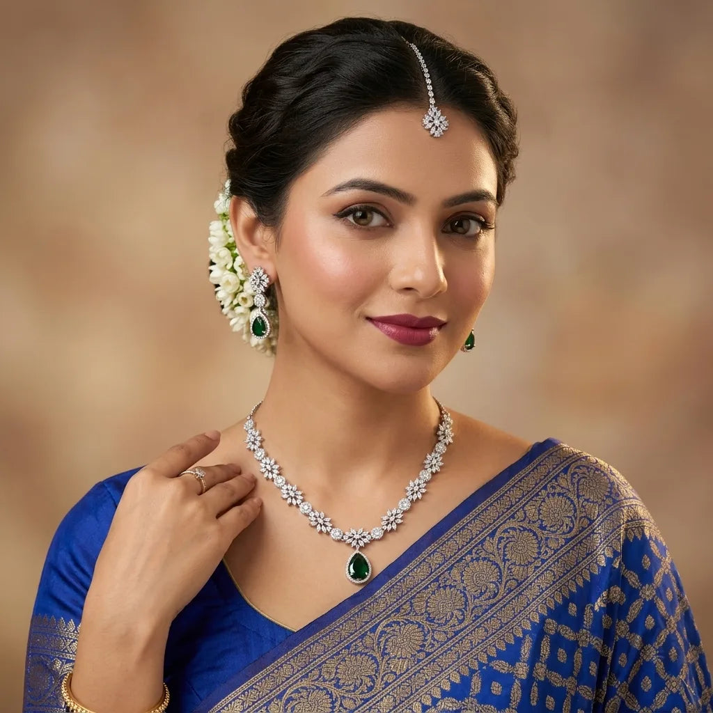 Woman wearing a blue saree with jewelry against a warm-toned background