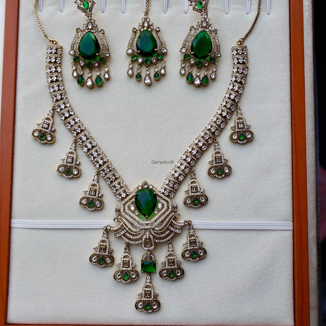 Ornate necklace with green gemstones on a white background