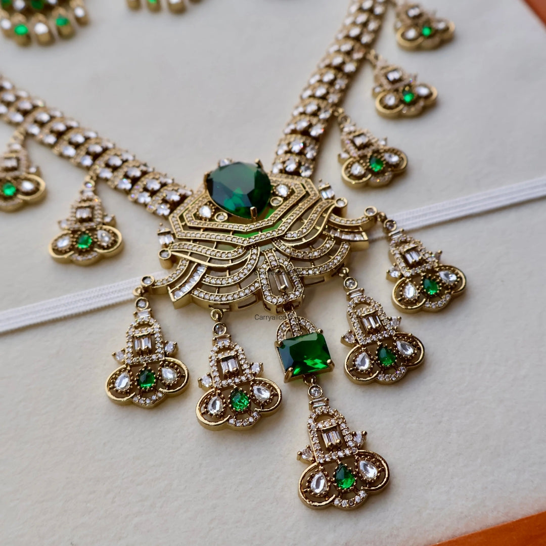 Ornate necklace with green gemstones on a light background