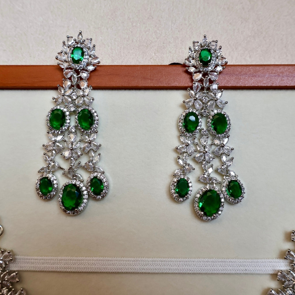 Pair of green gemstone earrings on a white background