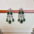 Pair of green gemstone earrings on a white background