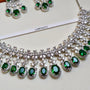 Jewelry set with green gemstones and silver accents on a white background, featuring the brand 'CARRYALCO'.