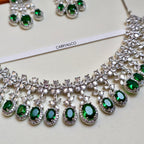 Jewelry set with green gemstones and silver accents on a white background, featuring the brand 'CARRYALCO'.