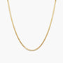 A delicate gold snake chain necklace shown against a plain white background.