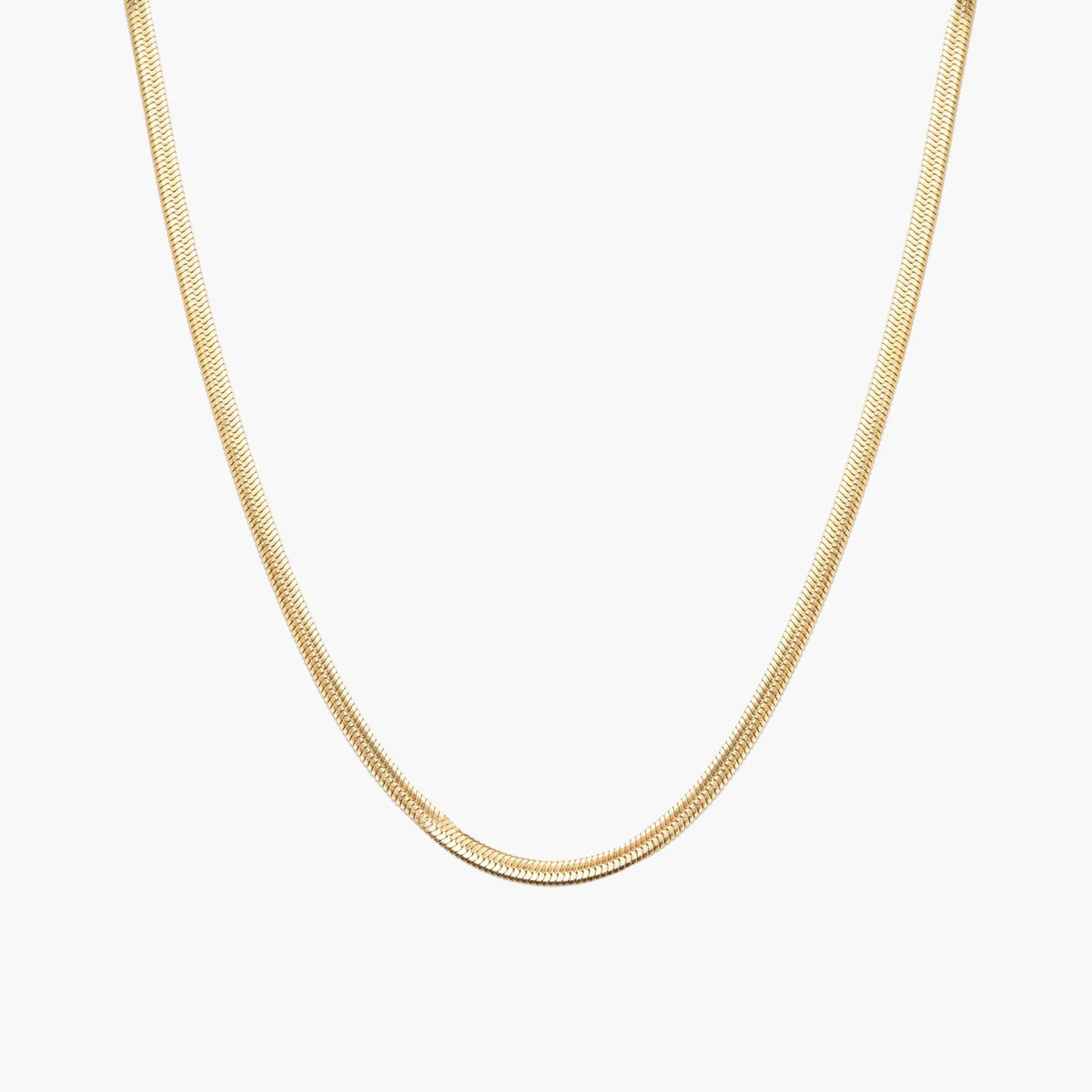 A delicate gold snake chain necklace shown against a plain white background.