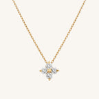 Gold necklace with a star-shaped diamond pendant on a white background