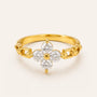 Gold ring with diamond flower design on a light beige background