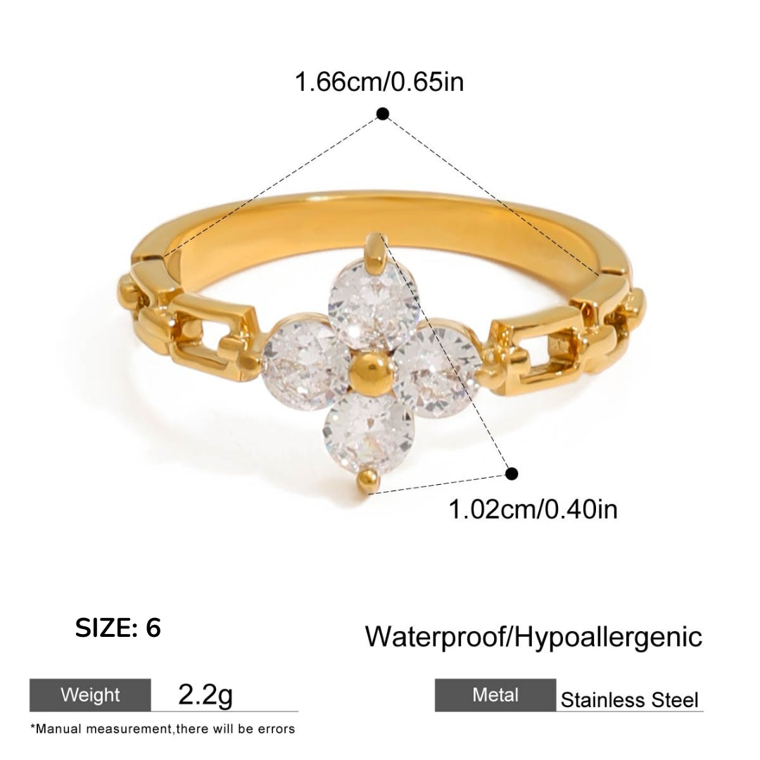 Gold ring with diamond-like stones and measurements on a white background