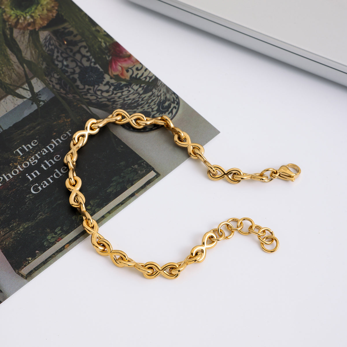 Gold chain bracelet on a book with a blurred background