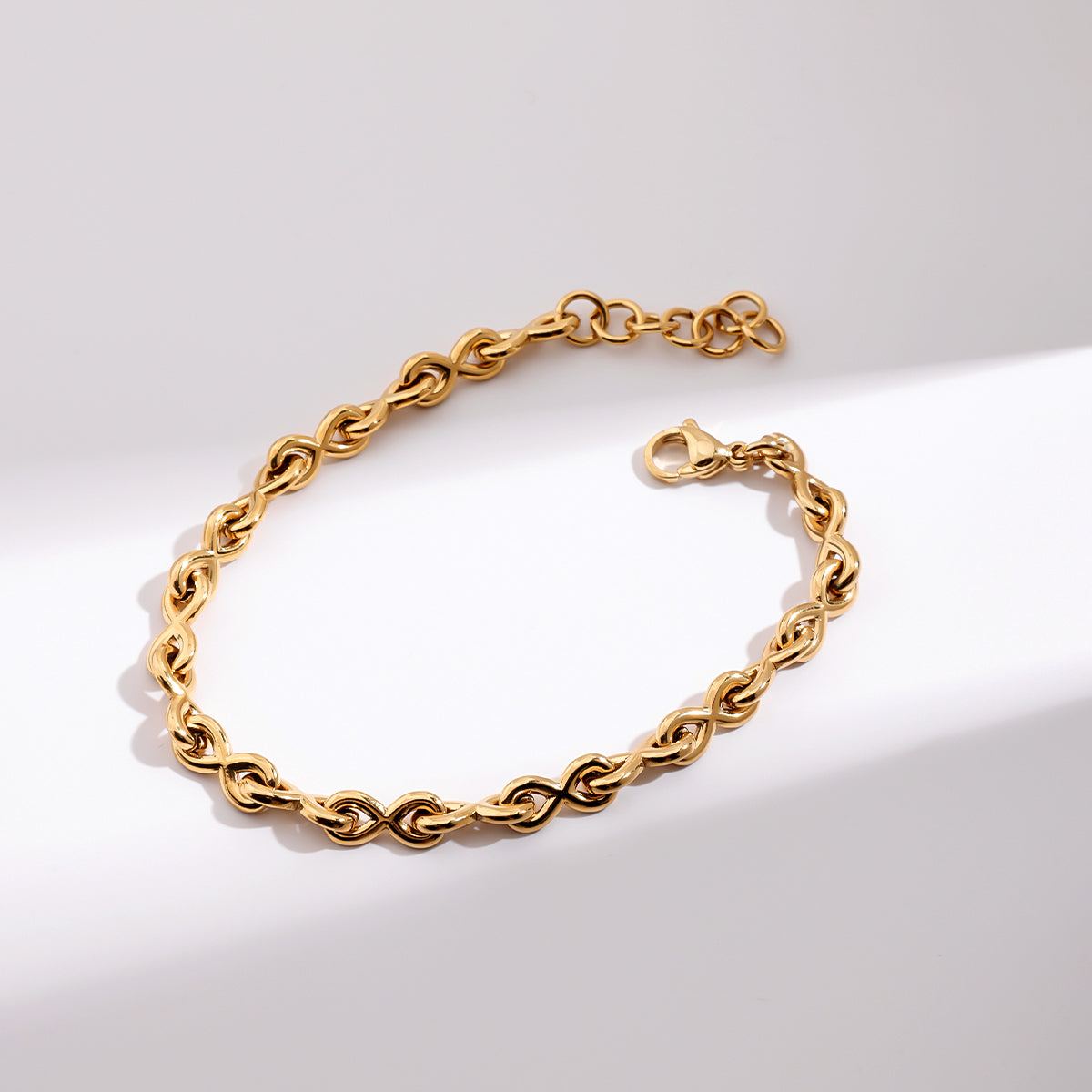 Gold chain bracelet on a white background