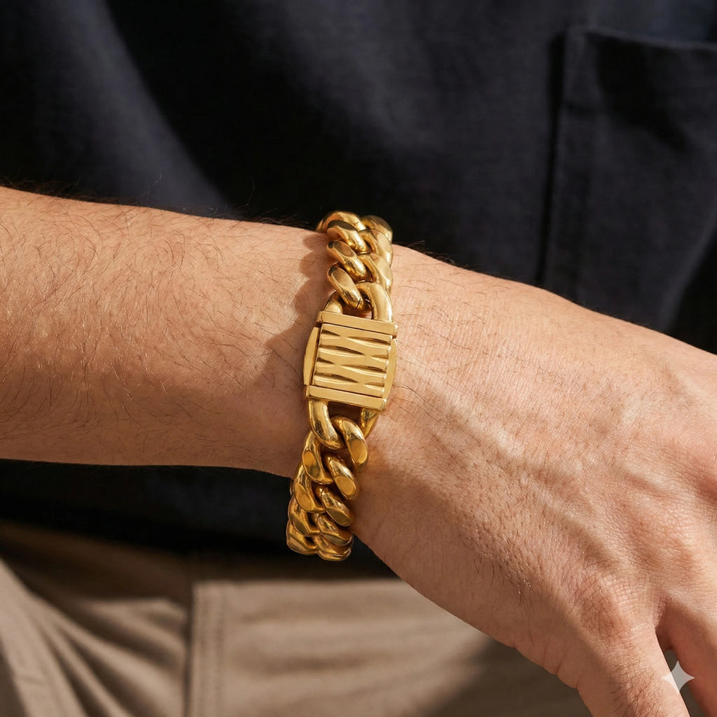 Gold chain bracelet on a wrist with a dark background