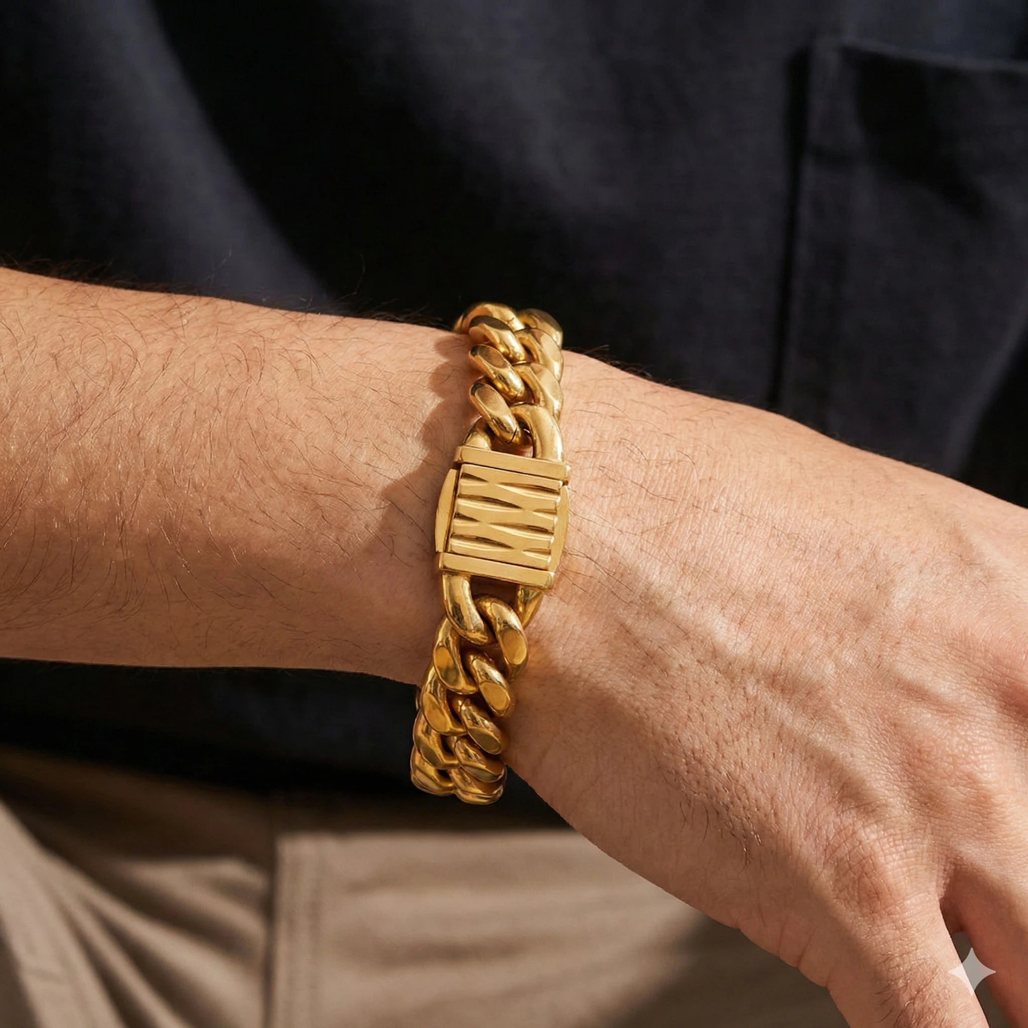 Gold chain bracelet on a wrist with a dark background