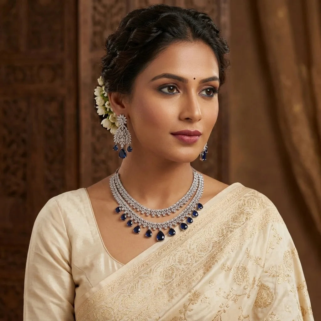 Woman wearing a traditional saree with jewelry against a brown background