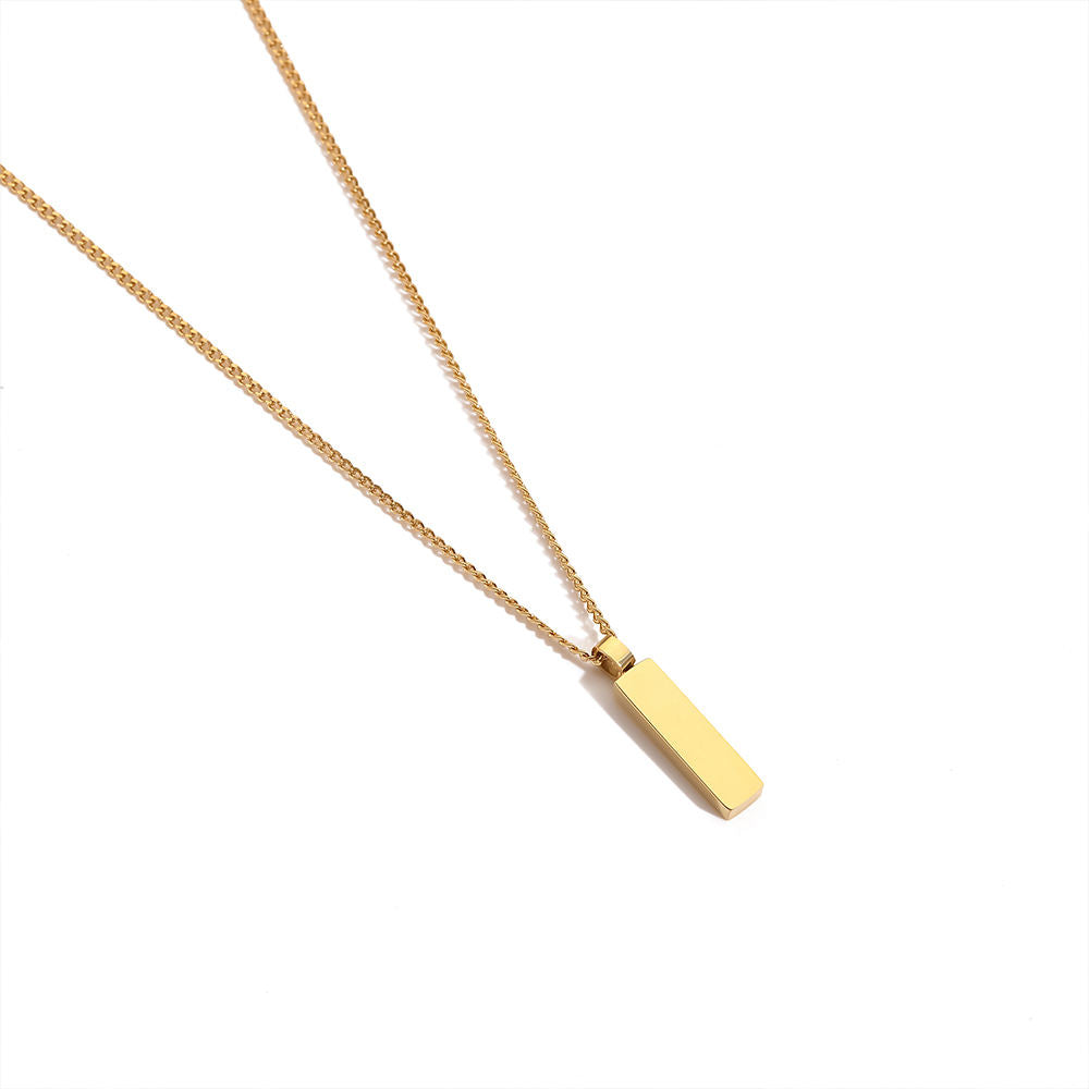 Gold necklace with a rectangular pendant on a white background