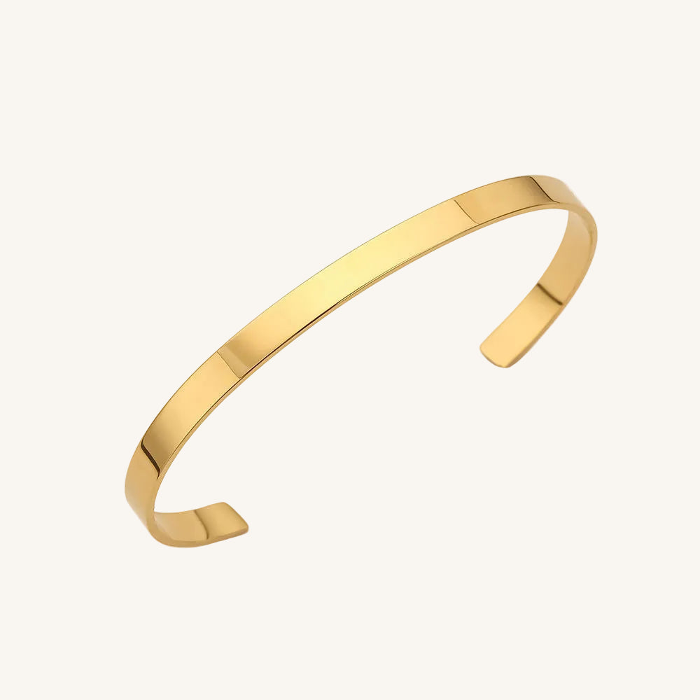Gold bangle on a white background