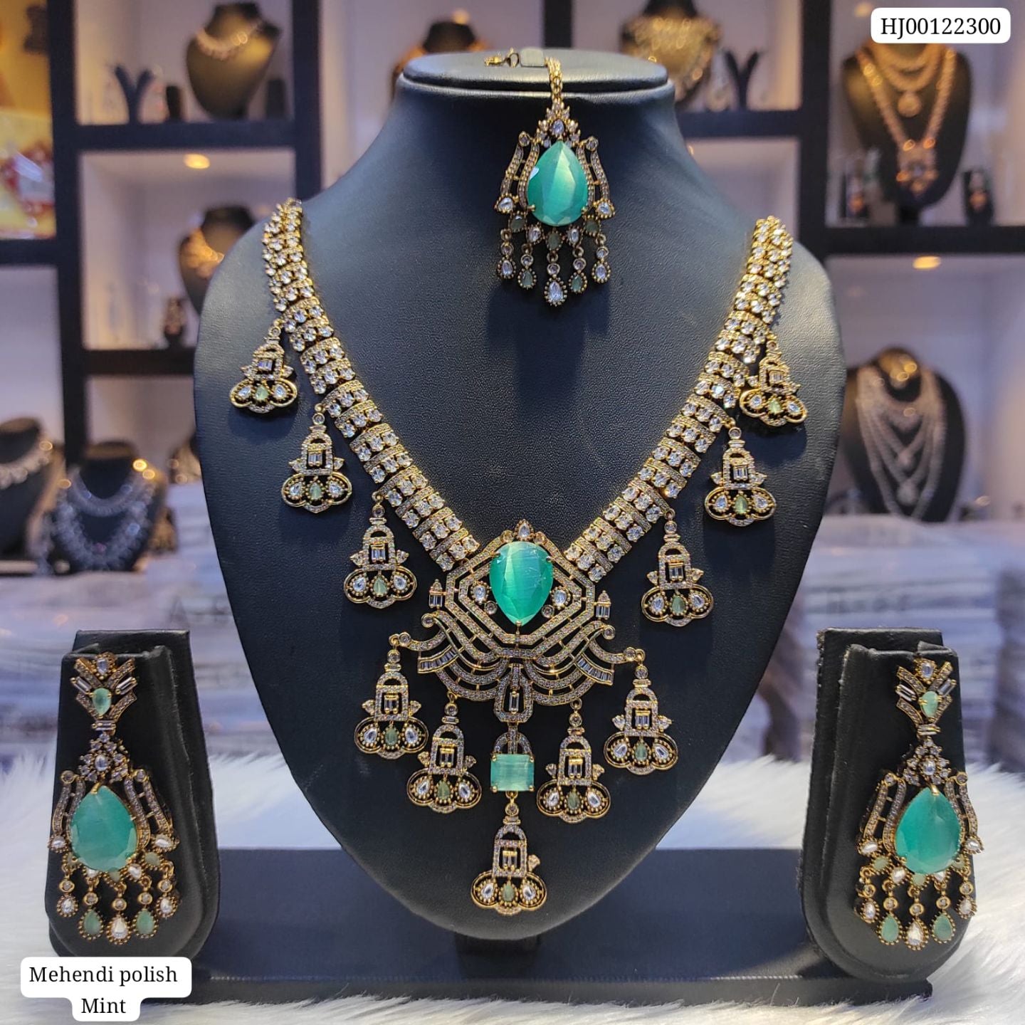 Ornate necklace and earrings set with turquoise stones on a mannequin bust.