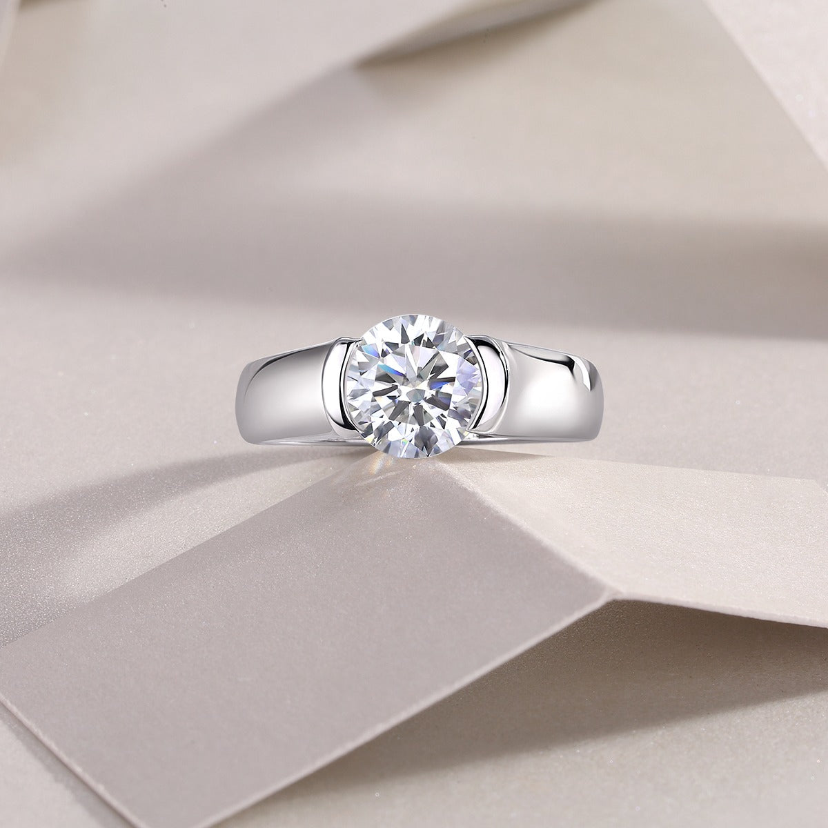 Silver ring with a diamond on a beige fabric background